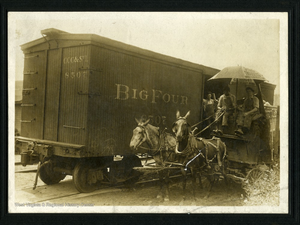 West Virginia teamsters with horse-drawn wagon and railroad boxcar circa 1900